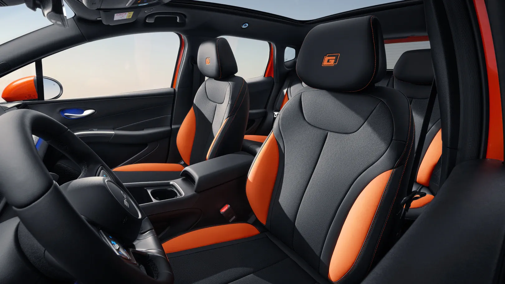 BYD Dolphin G interior cabin with orange accents and steering wheel