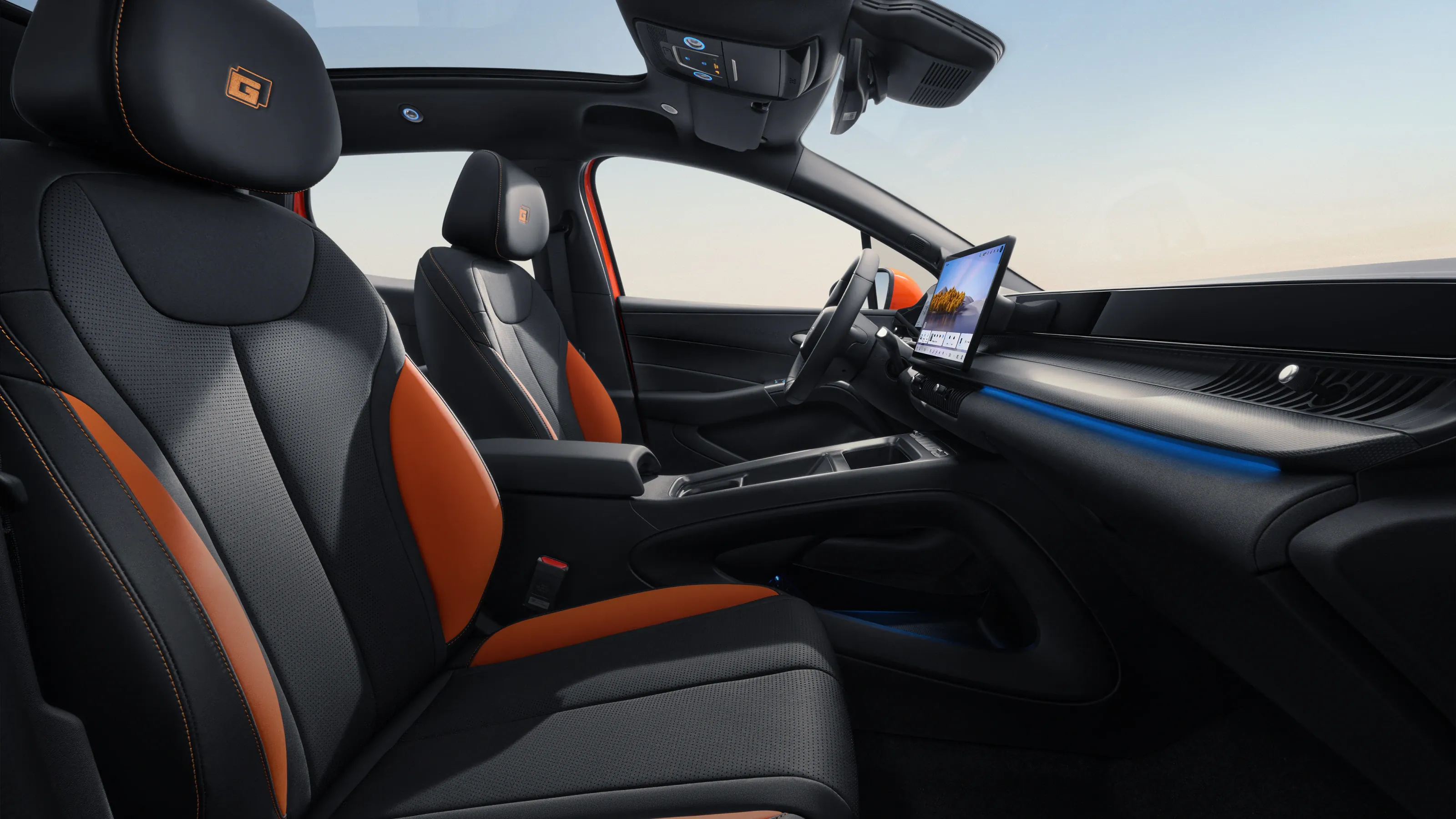 Orange and black artificial suede sports seats with dashboard infotainment