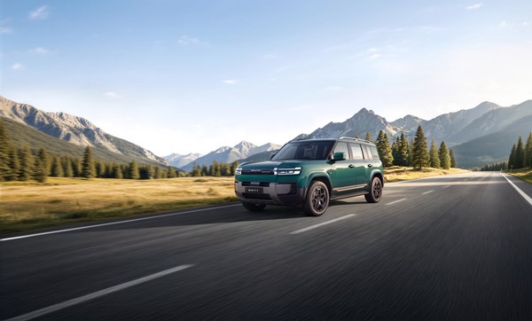 Teal BYD Ti7 SUV driving on a mountain valley highway