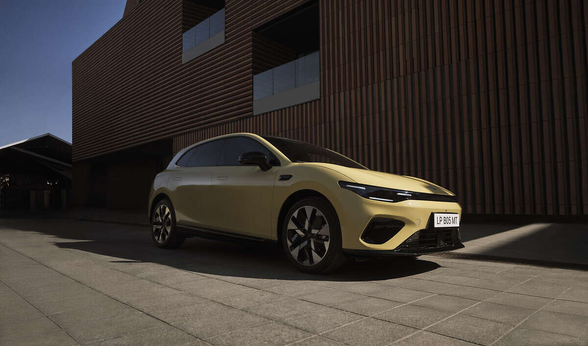 Yellow Leapmotor B05 parked against a modern brown corrugated building showing exterior design