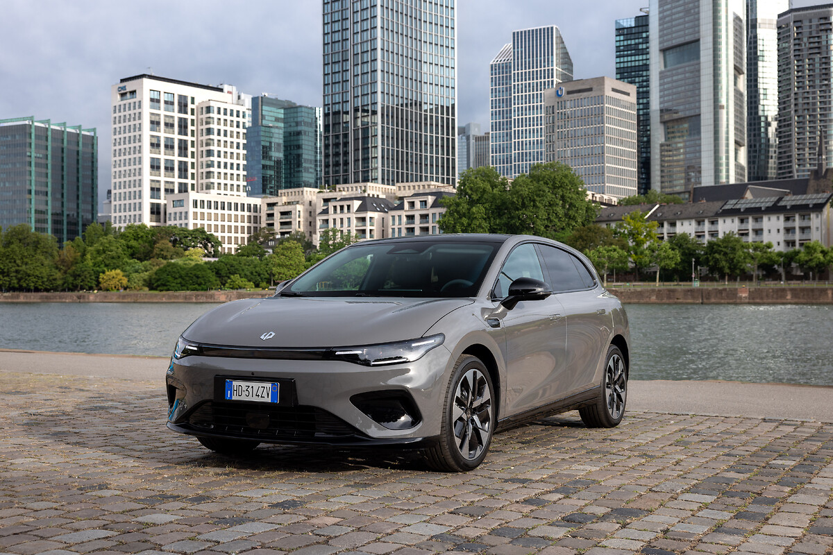 Silver Leapmotor B05 front three-quarter view parked by waterfront with city skyline