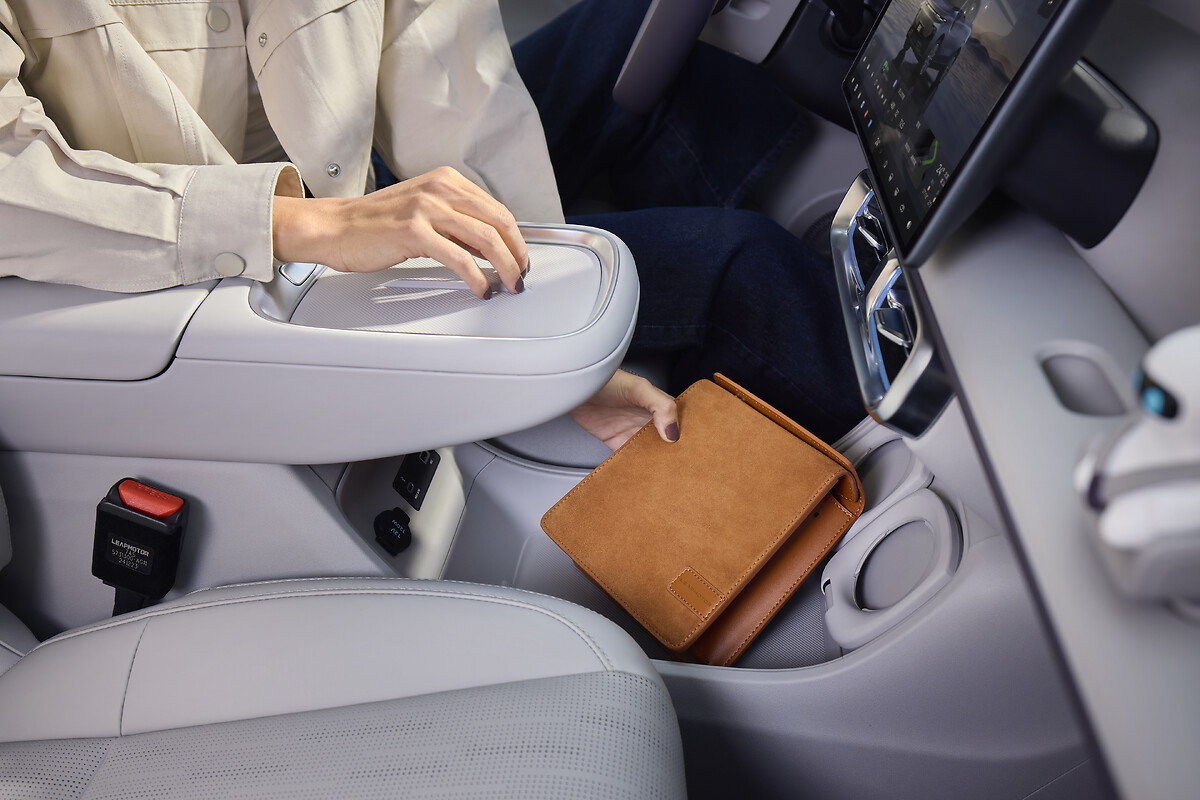 Close-up of centre console armrest with dual wireless charging pads
