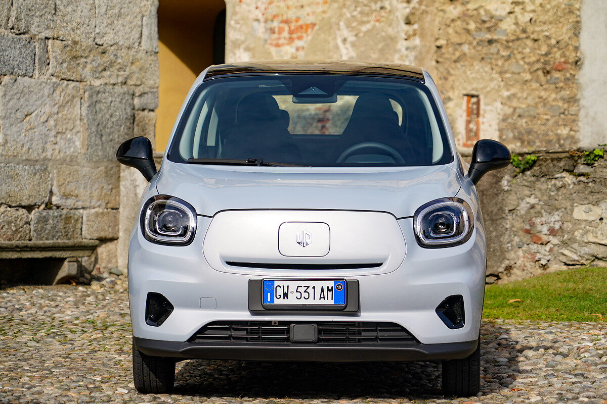 White Leapmotor T03 front view parked at a historic stone building