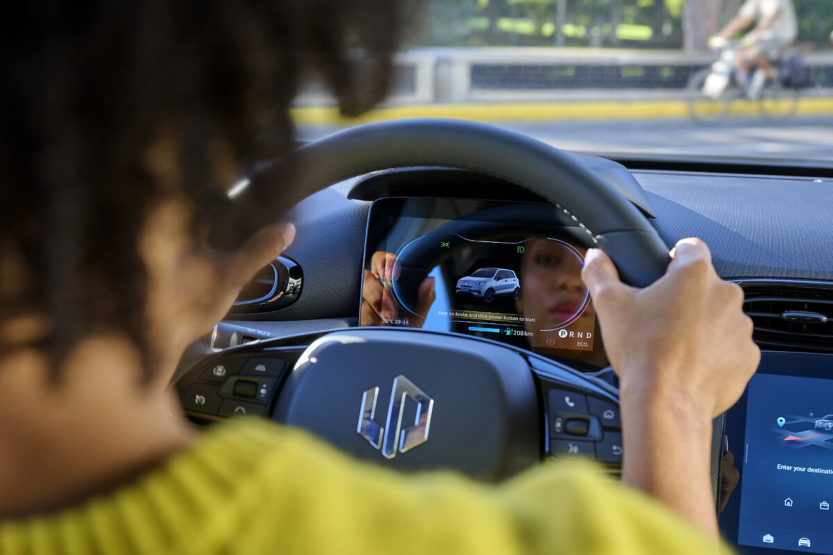Driver's hands on multifunction steering wheel with 8-inch digital dashboard display