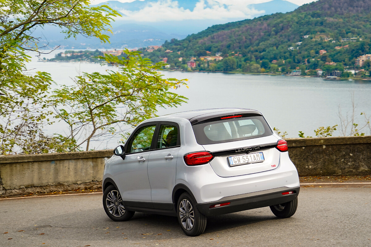 White Leapmotor T03 rear three-quarter view with lake scenery