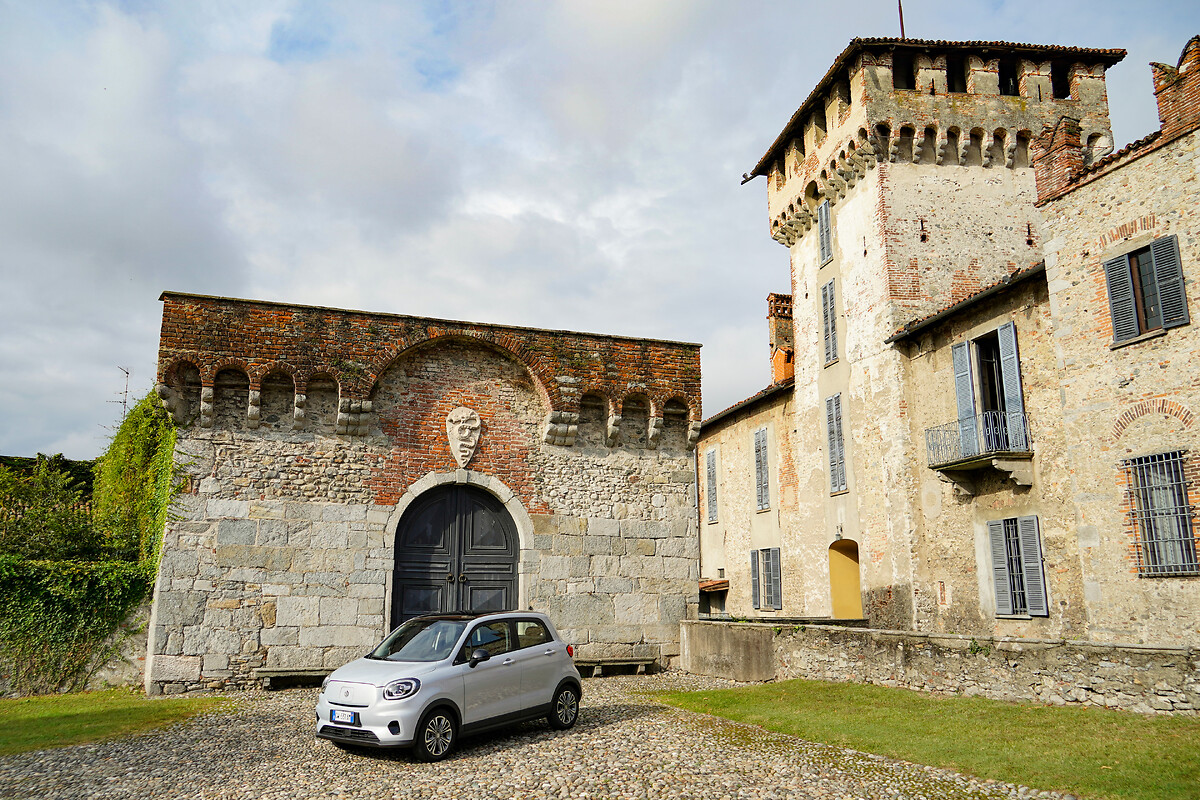 White Leapmotor T03 parked at a historic stone castle entrance