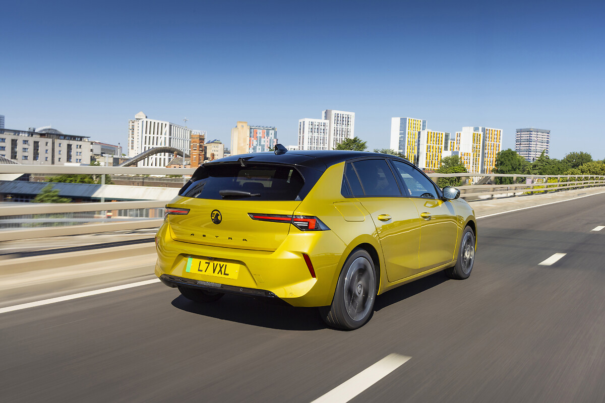 Yellow Vauxhall Astra rear view driving on urban highway