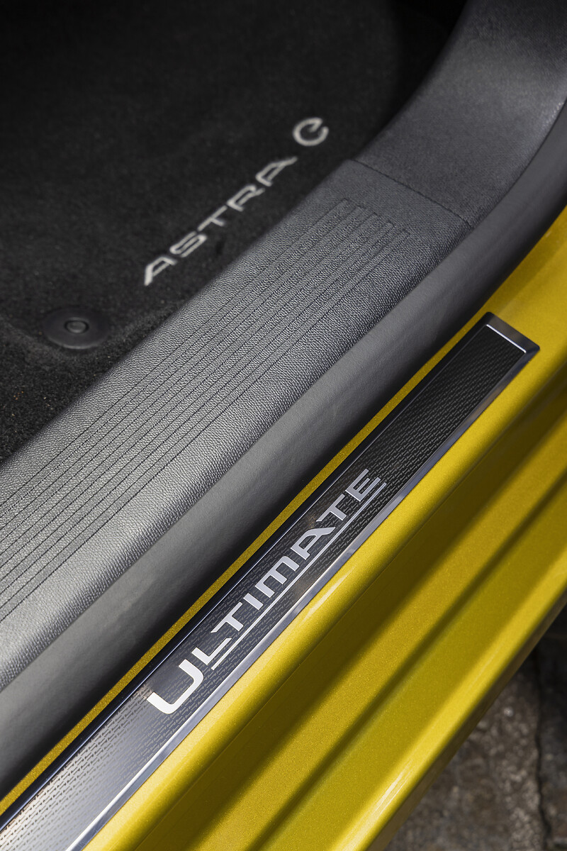 Door sill trim showing Astra and Ultimate badging on yellow car