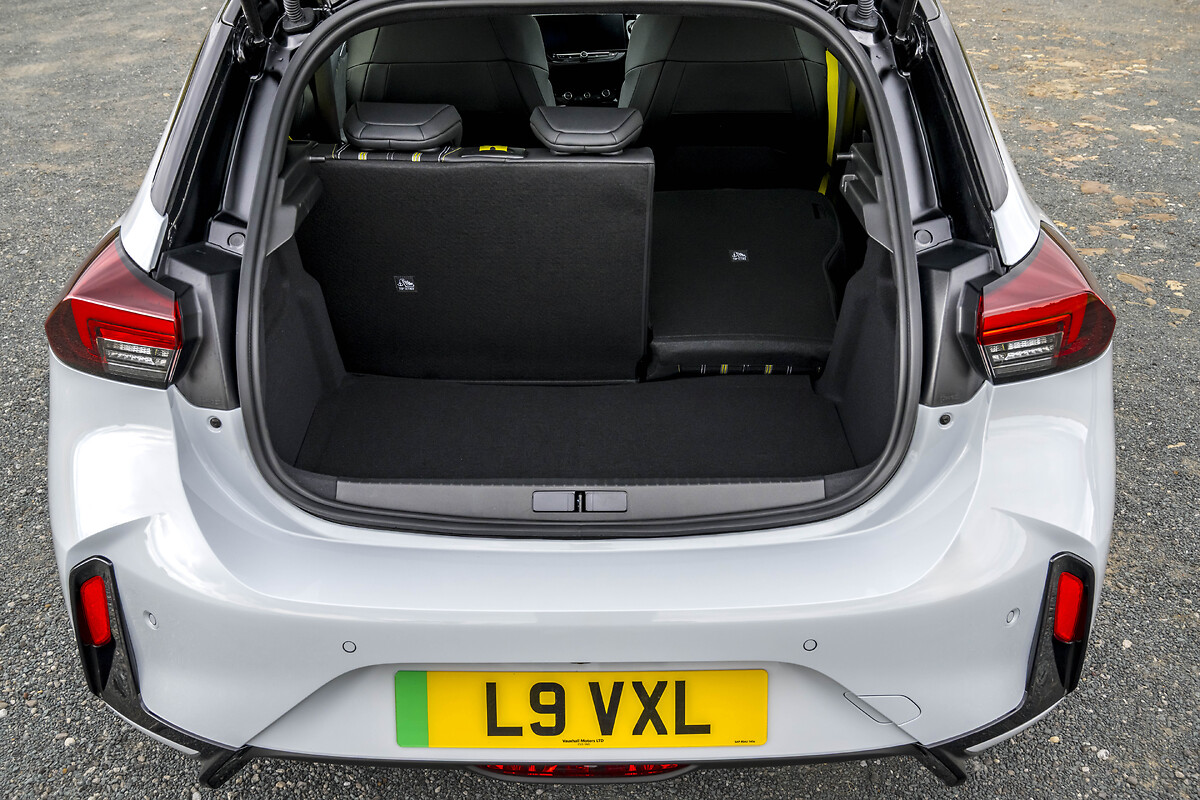 White Vauxhall Corsa open boot with folded rear seats