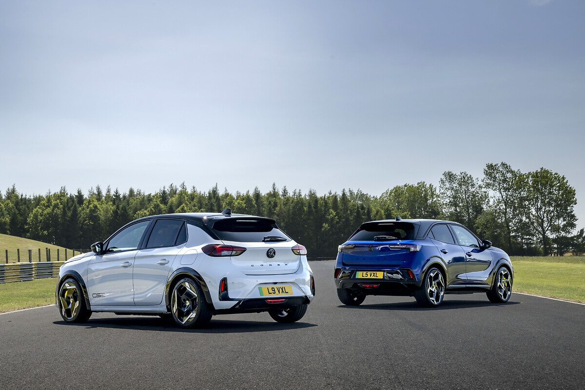 White and blue Vauxhall Corsa models rear three-quarter view